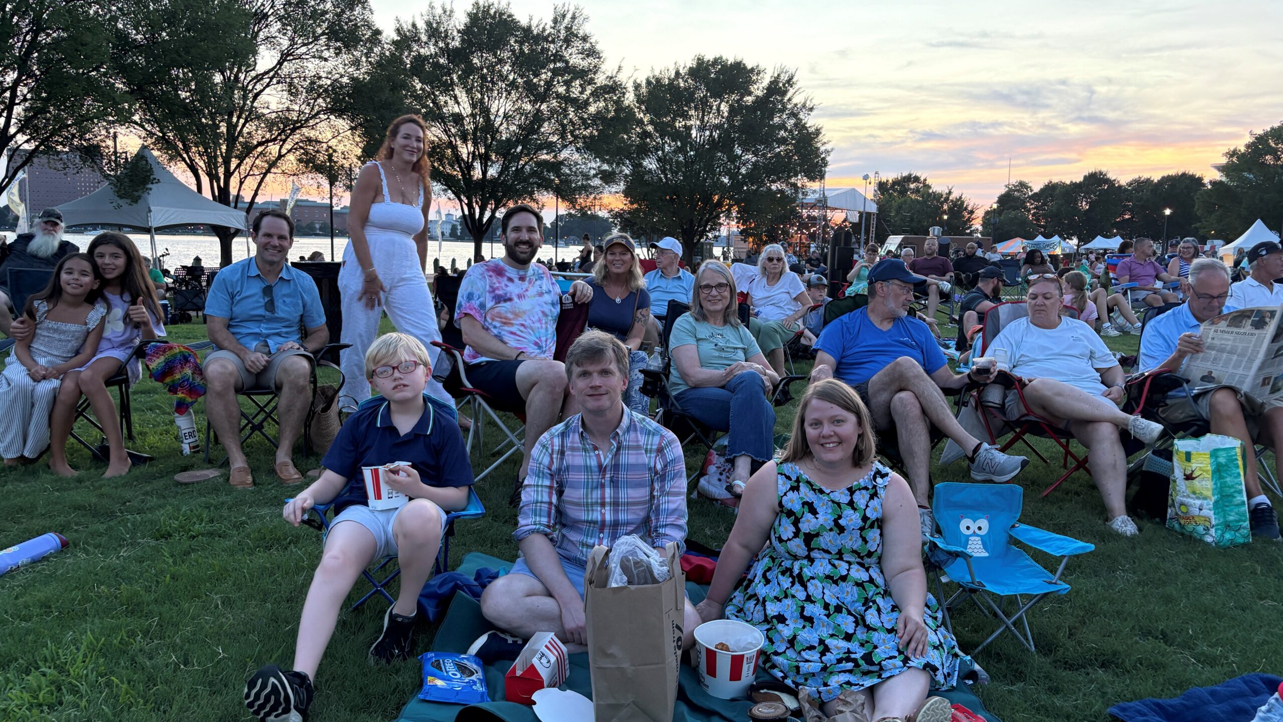 Parishioners sitting together at the park for a concert
